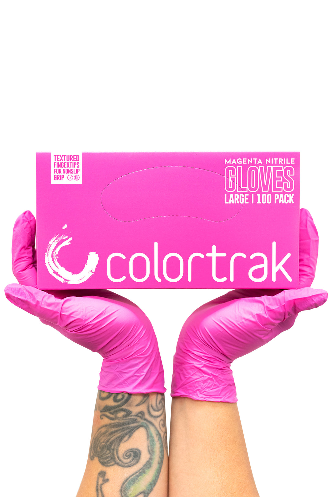 Two gloved hands holding a pink box of Colortrak magenta nitrile gloves, 100 pack