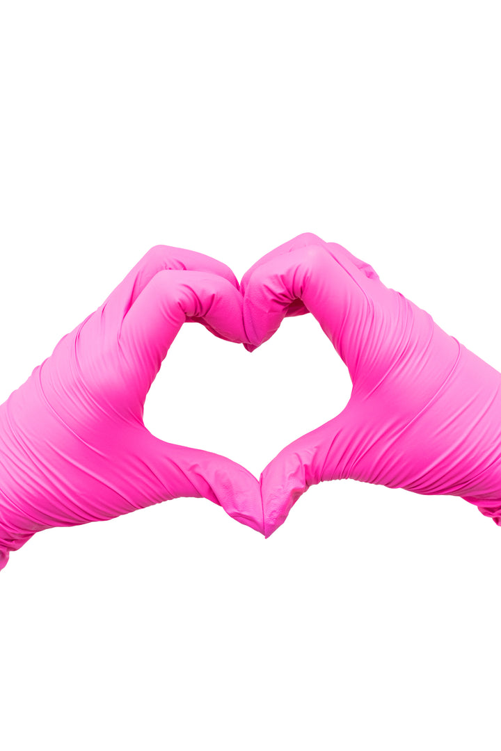 Two gloved hands forming a heart shape