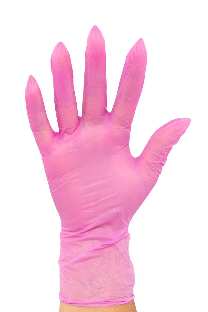Colortrak pink vinyl disposable glove worn on a hand, light pink and slightly sheer with a relaxed fit