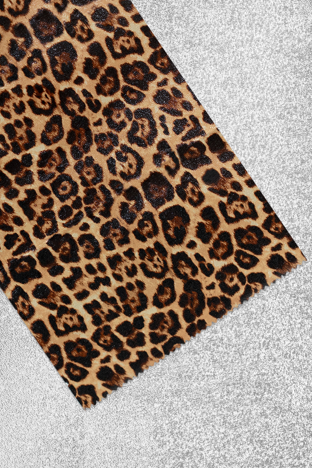 Foil sheet folded back to show the print up close: classic tan, brown and black leopard spots. Plain silver on the reverse side.