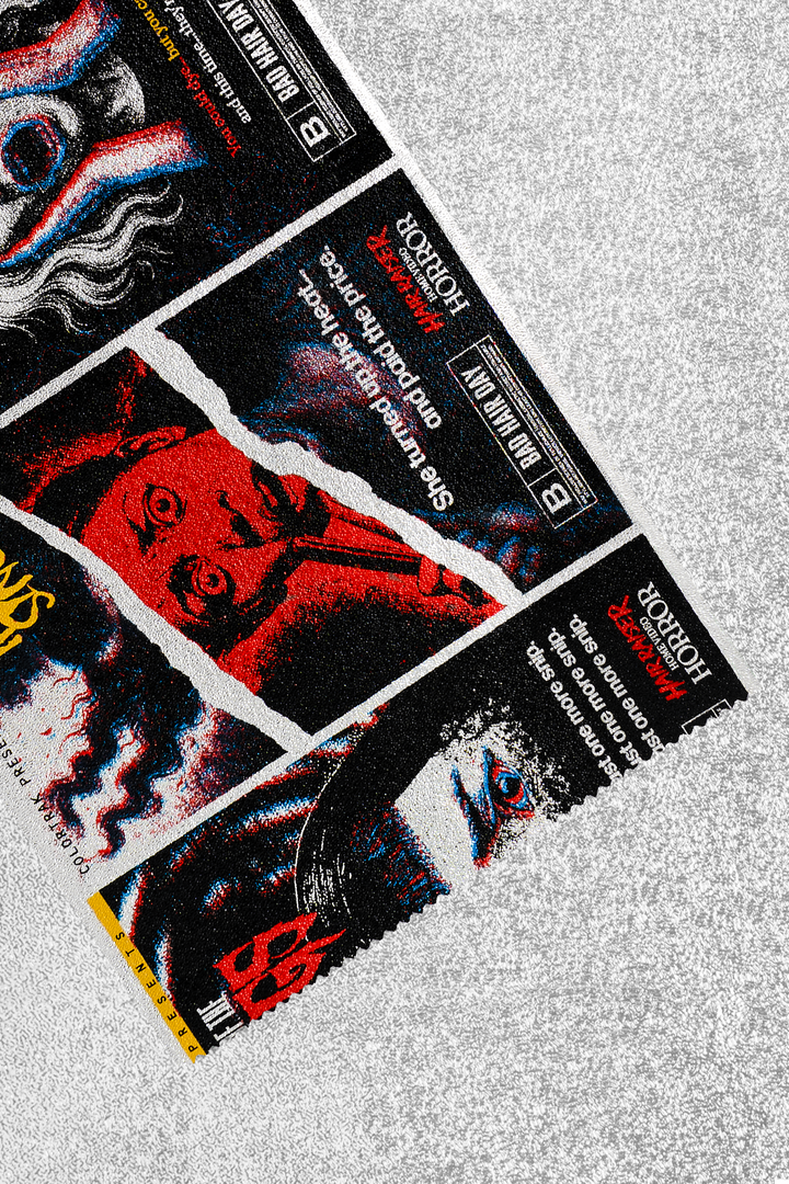 Foil sheet folded back to show the print up close: vintage horror VHS cover panels in black, white and red, with titles like Bad Hair Day and a red and blue 3D effect. Plain silver on the reverse side.