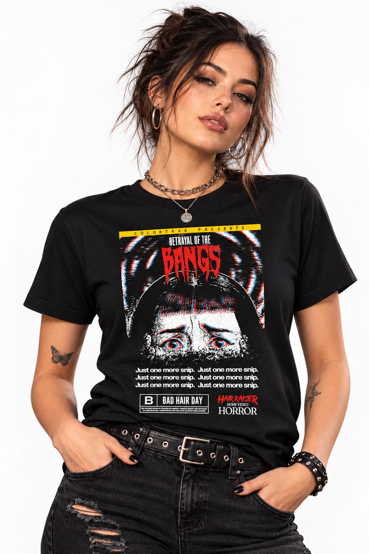 Model wearing the Hair Raiser black tee, front view: horror movie poster print with close-up eyes, a red Bangs headline and a yellow banner at the top