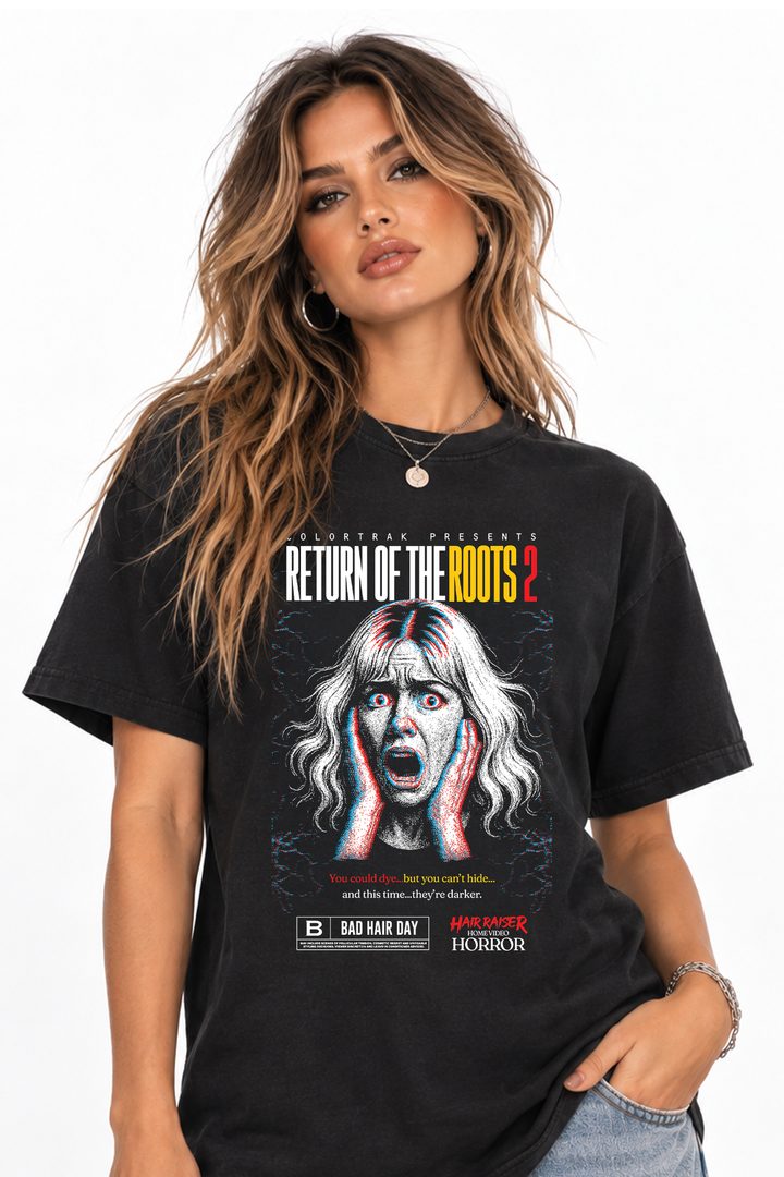 Model wearing the Hair Raiser black tee in the second design: horror poster print of a screaming woman with blonde hair and a Return of the Roots headline