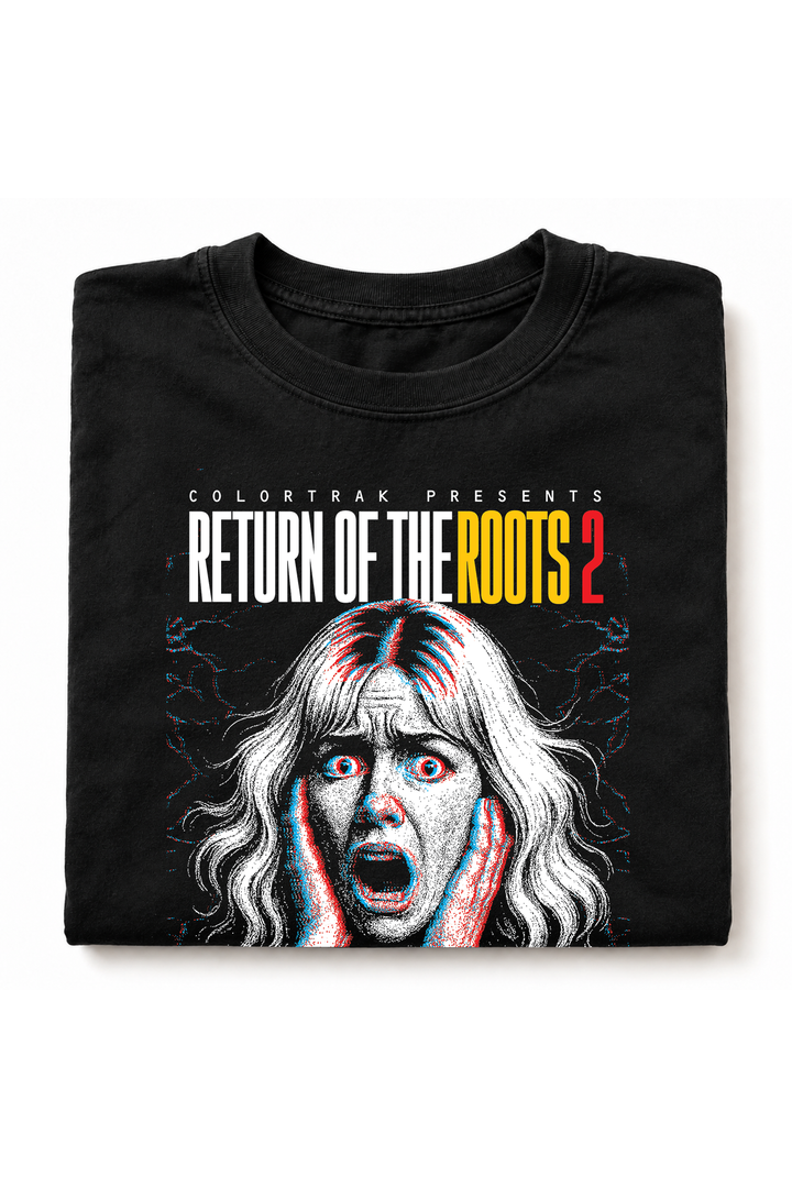 Folded black tee showing the screaming woman horror poster print with a yellow Return of the Roots headline